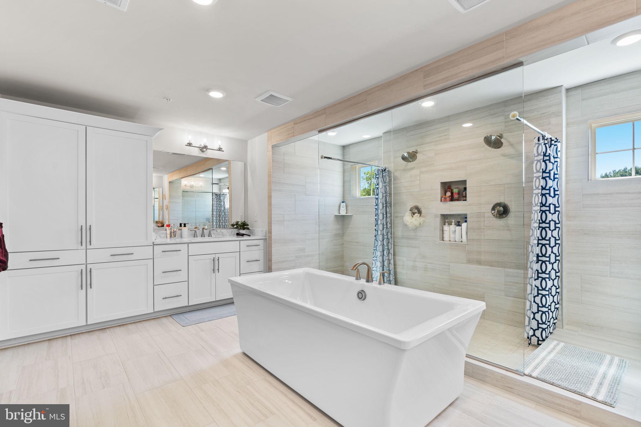 21708 Woodfield Road Gaithersburg, MD 20882 - Photo 28 of 76 a bathroom with a sink a toilet a mirror and shower