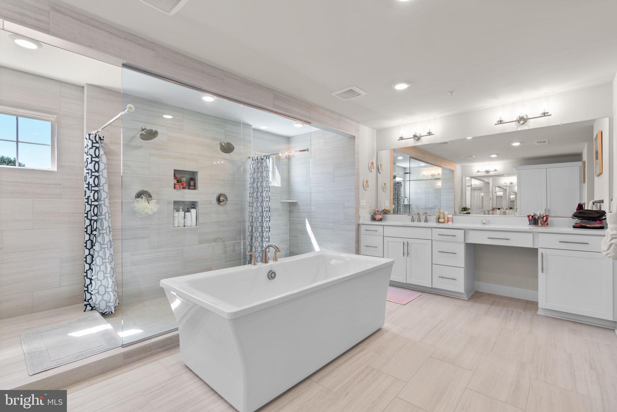 21708 Woodfield Road Gaithersburg, MD 20882 - Photo 30 of 76 a large white bathroom with a double vanity sink a mirror and a shower