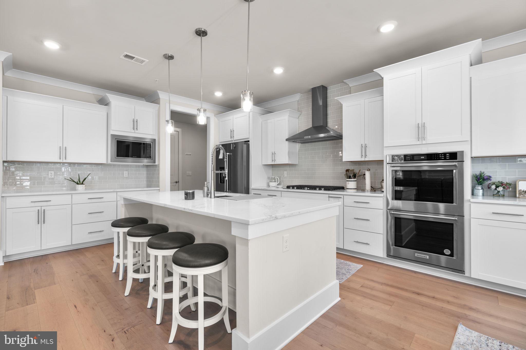 21708 Woodfield Road Gaithersburg, MD 20882 - Photo 3 of 76 a kitchen with a stove a sink and a refrigerator
