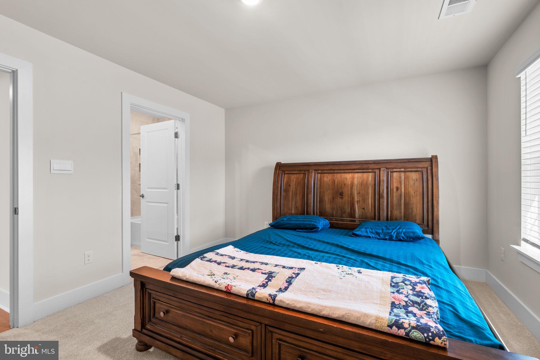 21708 Woodfield Road Gaithersburg, MD 20882 - Photo 37 of 76 a bedroom with a bed and window