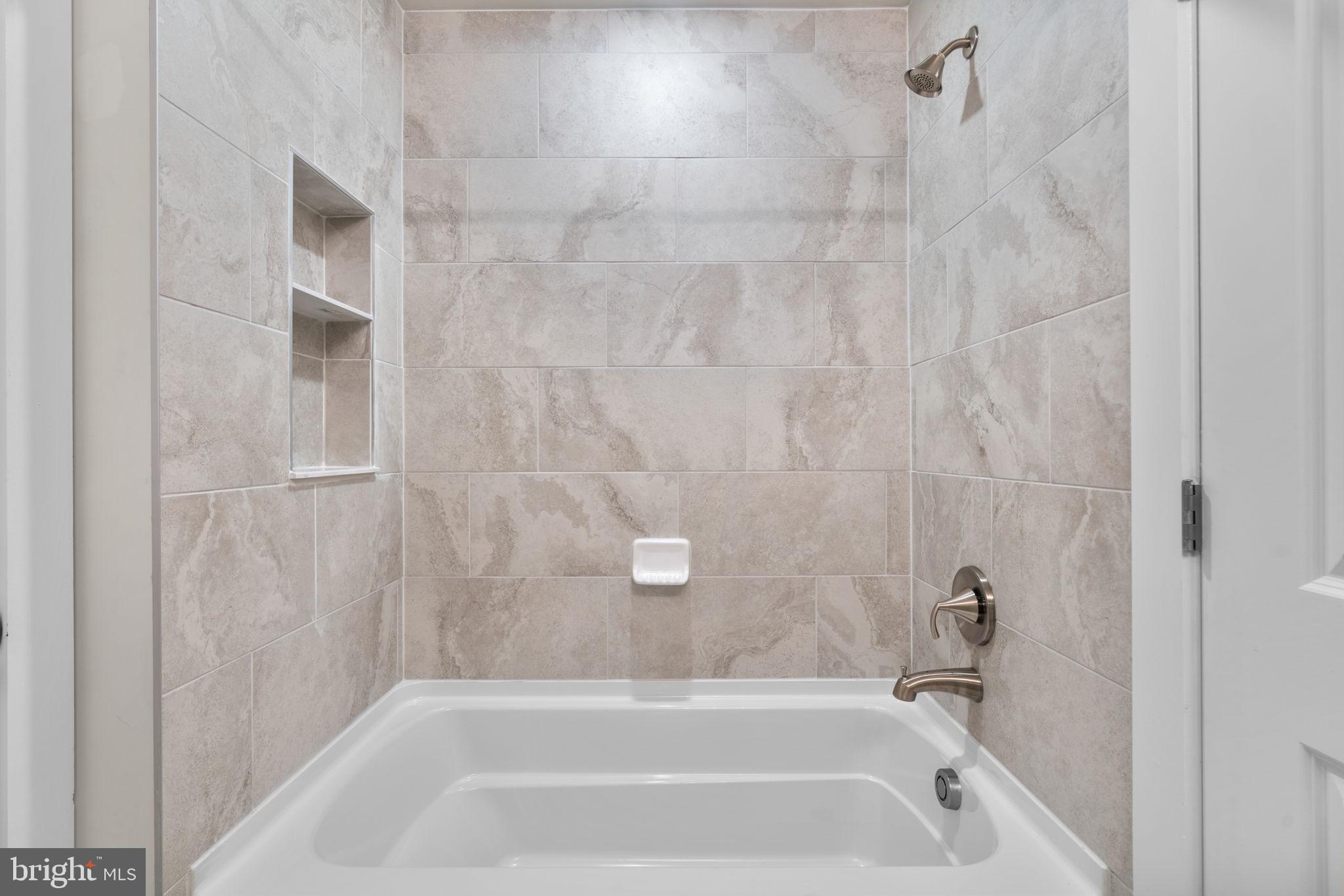 21708 Woodfield Road Gaithersburg, MD 20882 - Photo 40 of 76 a bathroom with a bathtub
