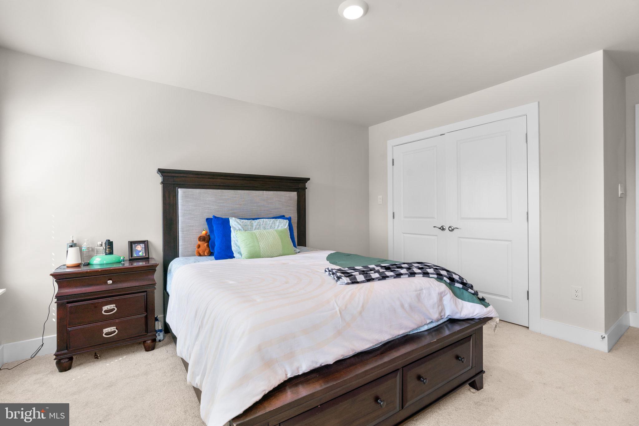 21708 Woodfield Road Gaithersburg, MD 20882 - Photo 45 of 76 a bedroom with a bed and a dresser