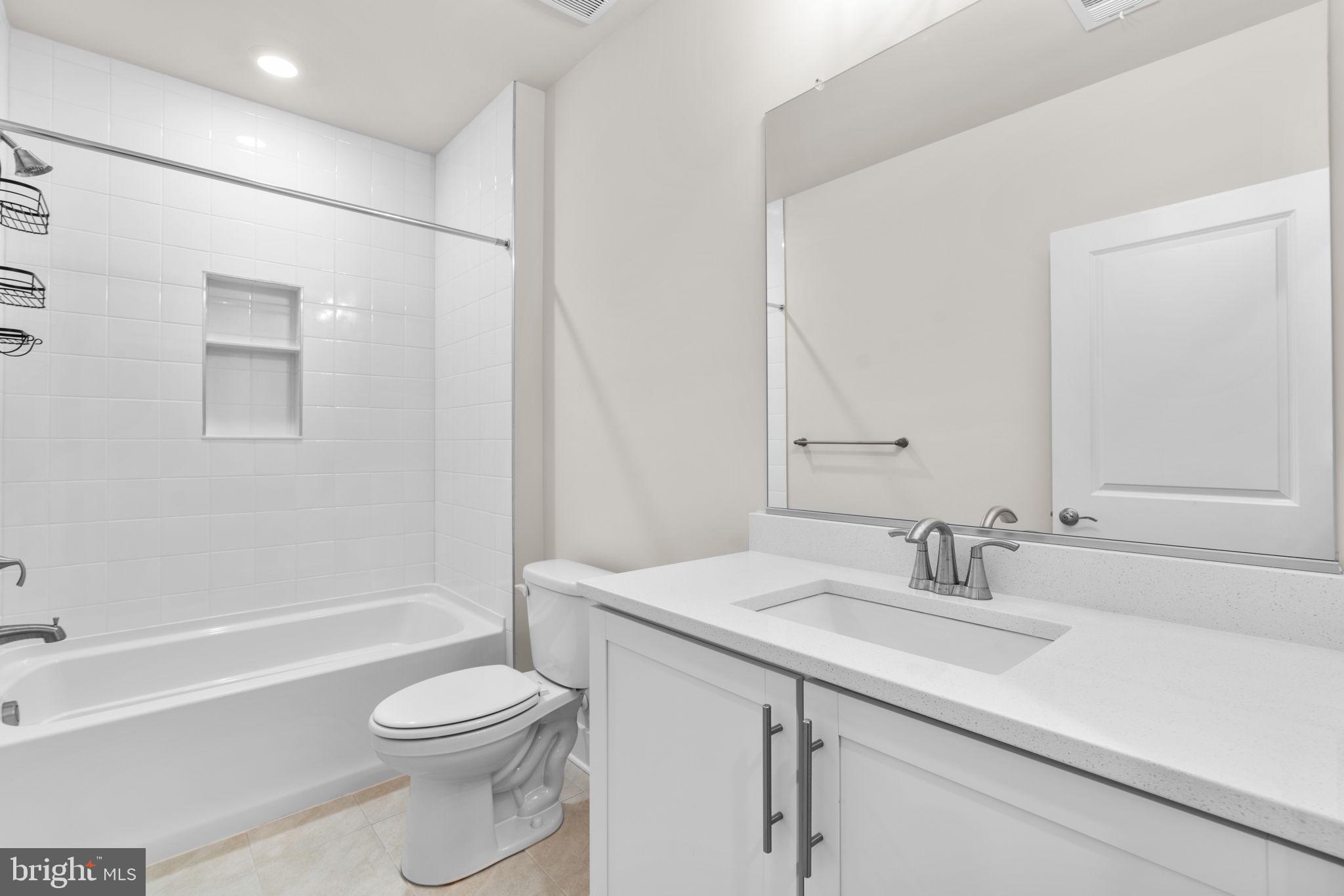 21708 Woodfield Road Gaithersburg, MD 20882 - Photo 48 of 76 a bathroom with a sink a toilet and shower