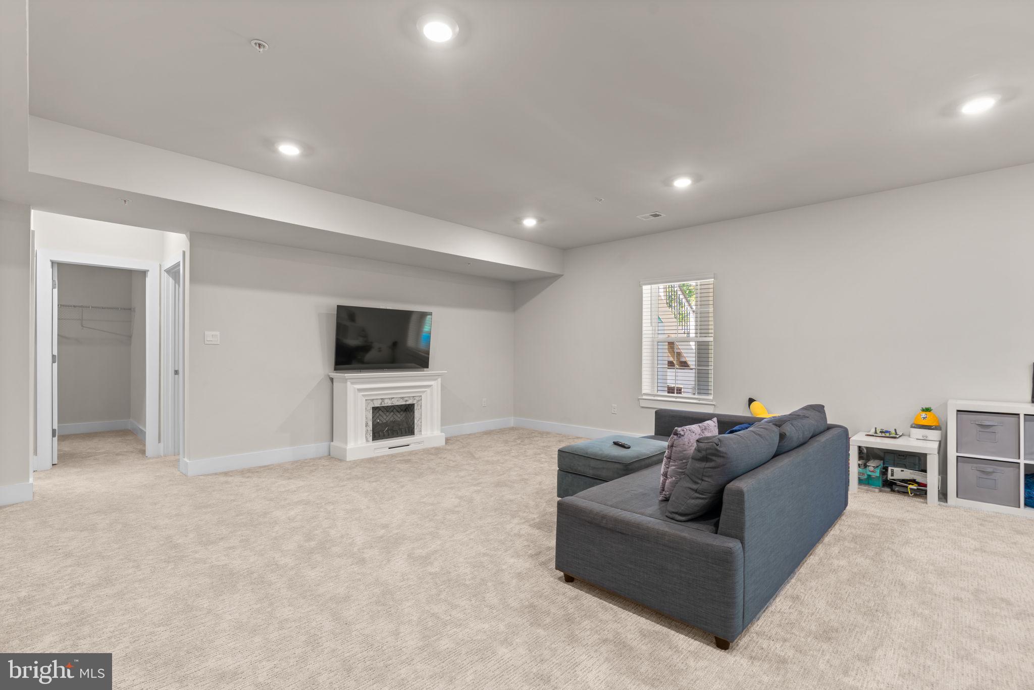 21708 Woodfield Road Gaithersburg, MD 20882 - Photo 54 of 76 a living room with furniture and a flat screen tv