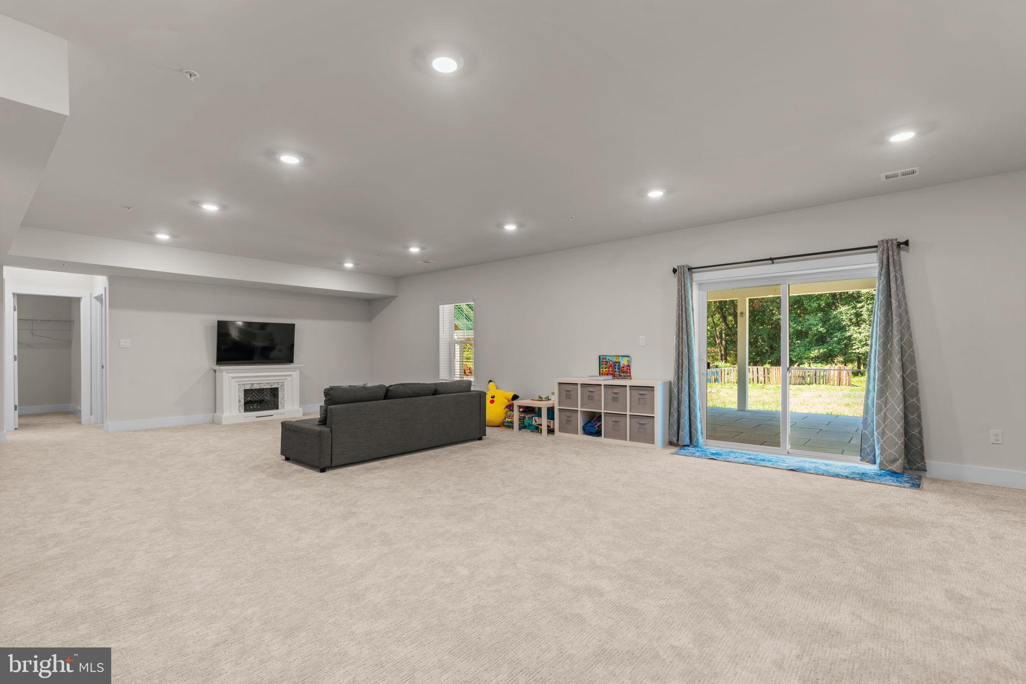 21708 Woodfield Road Gaithersburg, MD 20882 - Photo 55 of 76 a living room with furniture and a large window