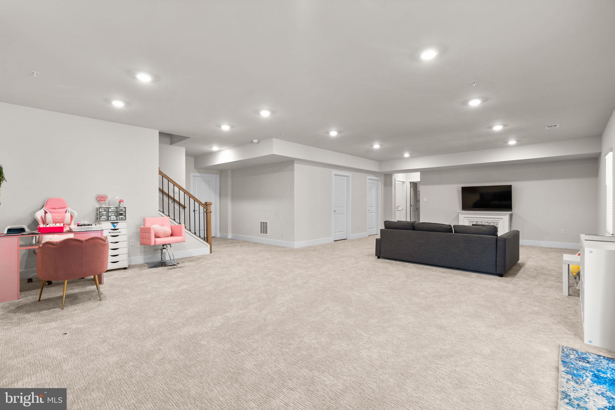 21708 Woodfield Road Gaithersburg, MD 20882 - Photo 56 of 76 a living room with furniture and a flat screen tv