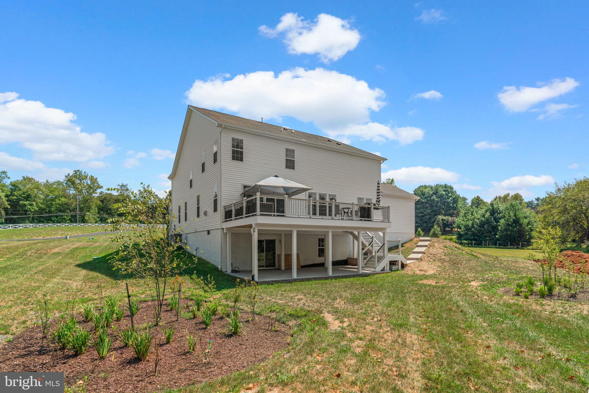 21708 Woodfield Road Gaithersburg, MD 20882 - Photo 63 of 76 a view of a house with a yard