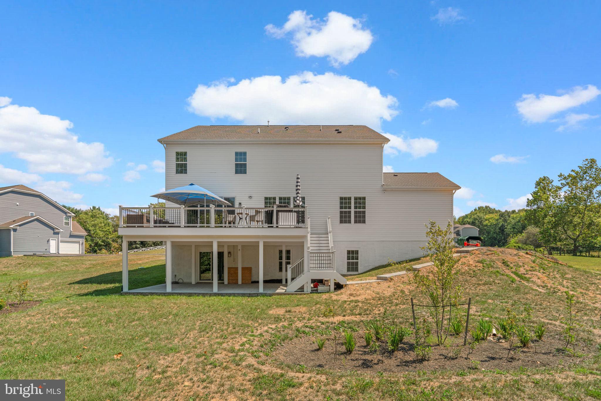 21708 Woodfield Road Gaithersburg, MD 20882 - Photo 64 of 76 a view of a house with a yard
