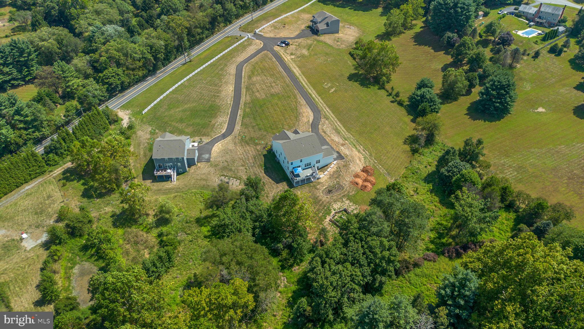 21708 Woodfield Road Gaithersburg, MD 20882 - Photo 72 of 76 an aerial view of a house with a yard and lake view