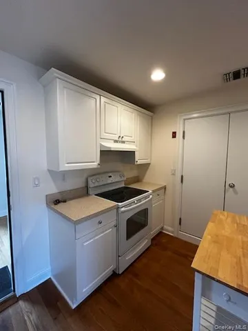 a kitchen with wooden cabinets and a stove top oven