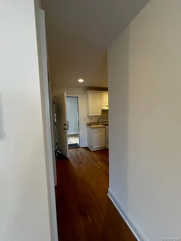 a view of a kitchen from the hallway