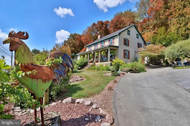 a front view of a house with a yard and outdoor seating