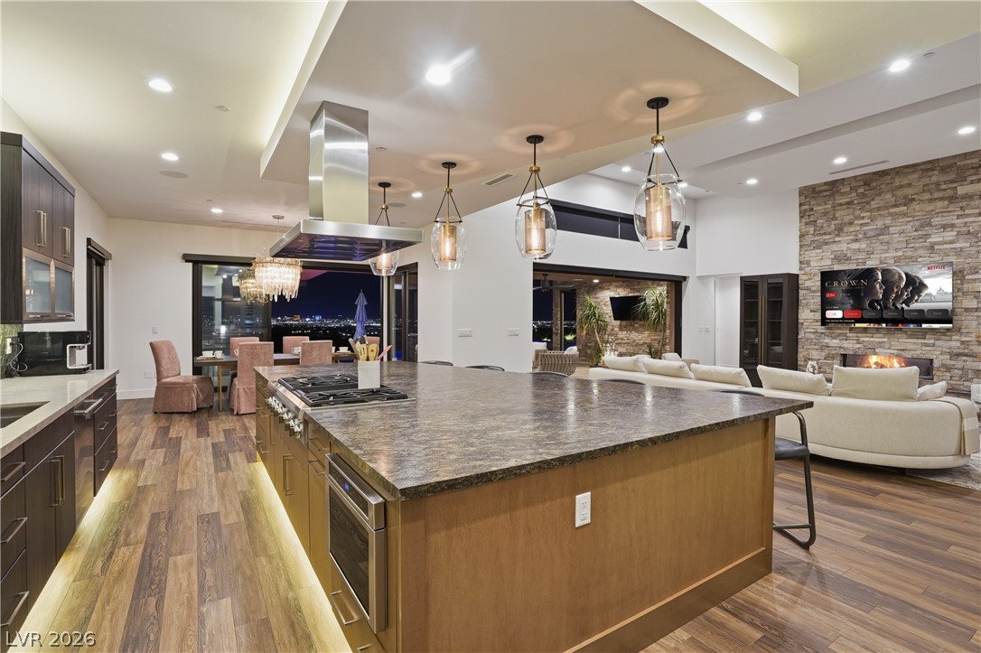 2224 Ledge Rock Lane Henderson, NV 89052 - Photo 14 of 66 Elevated gourmet kitchen with accent lighting, Thermador appliances, mosaic tile backsplash, double oven, and seamless indoor outdoor living