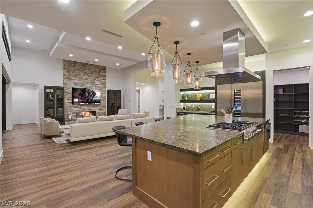 2224 Ledge Rock Lane Henderson, NV 89052 - Photo 22 of 66 Elevated gourmet kitchen with accents lighting, oversized leathered granite island, Thermador appliances, mosaic tile backsplash, double oven, and seamless indoor outdoor living