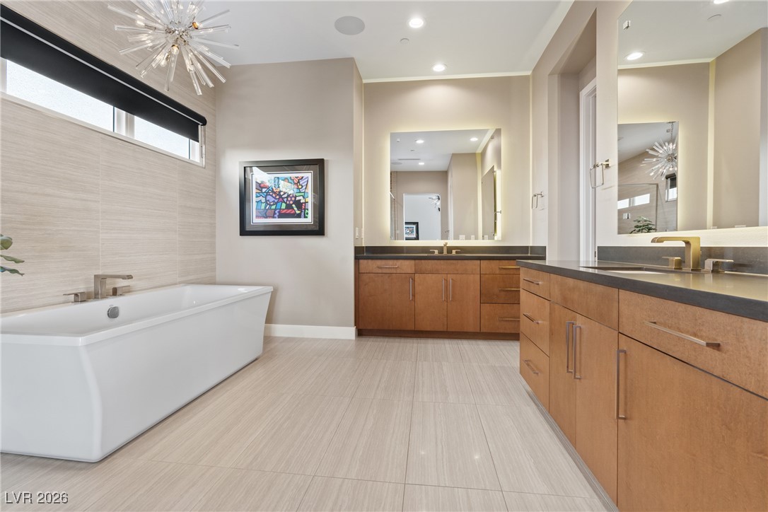 2224 Ledge Rock Lane Henderson, NV 89052 - Photo 30 of 66 Primary bathroom with standalone tub and shower, LED dual vanities, and wrap around finished closet