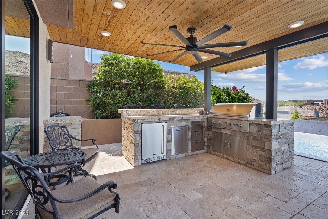 2224 Ledge Rock Lane Henderson, NV 89052 - Photo 47 of 66 Infinity edge pool and spa, and covered outdoor kitchen