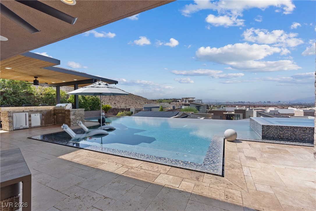 2224 Ledge Rock Lane Henderson, NV 89052 - Photo 48 of 66 Infinity edge pool and spa, and covered outdoor kitchen