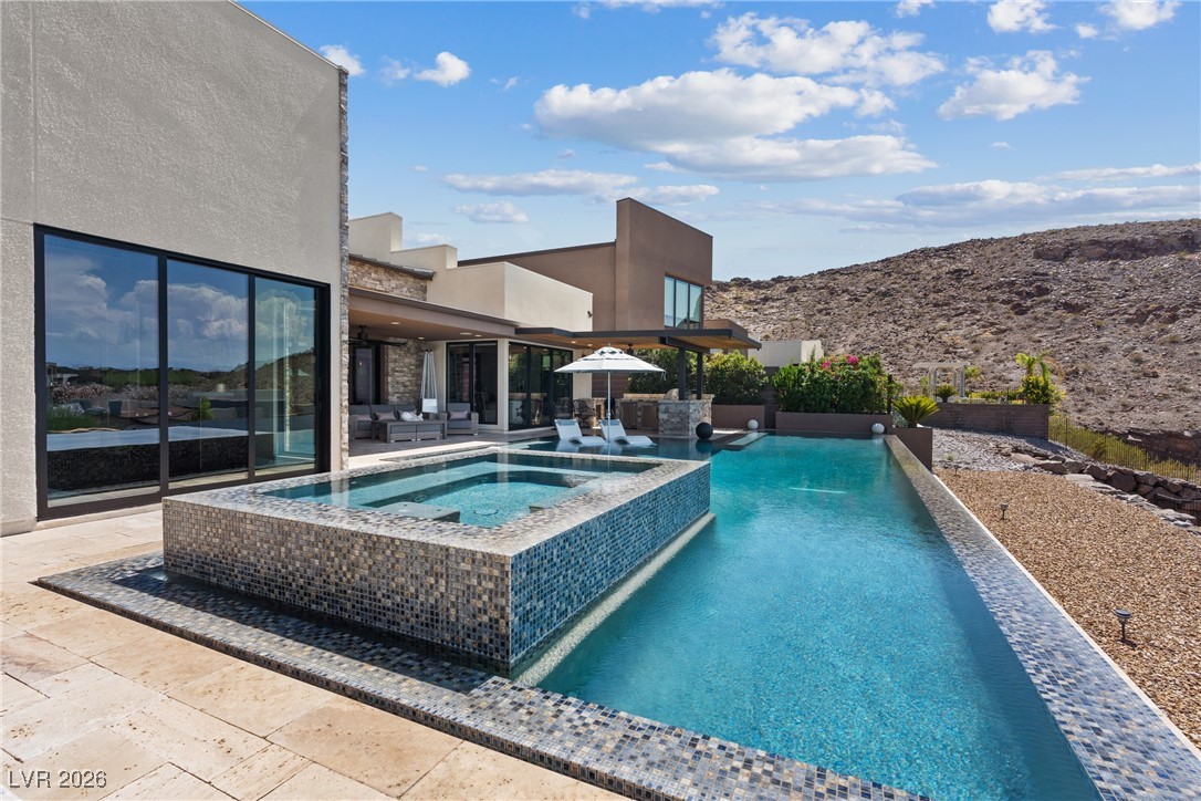 2224 Ledge Rock Lane Henderson, NV 89052 - Photo 53 of 66 Infinity edge pool and spa, and covered outdoor kitchen