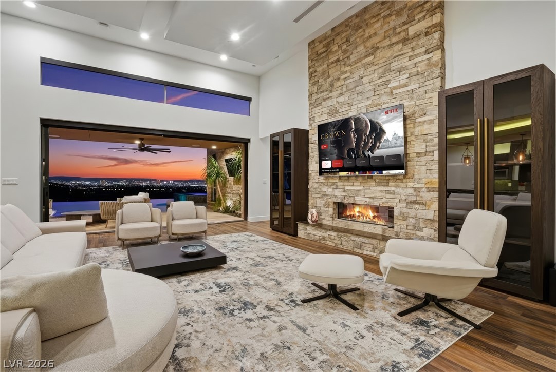 2224 Ledge Rock Lane Henderson, NV 89052 - Photo 9 of 66 Living room with vaulted ceiling, fireplace, open concept layout with surround sound, pocket & stacking doors, and accent lighting throughout