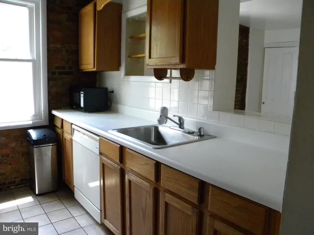 a kitchen with a sink and a refrigerator
