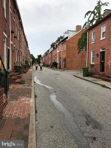 a view of a street with a building in the background