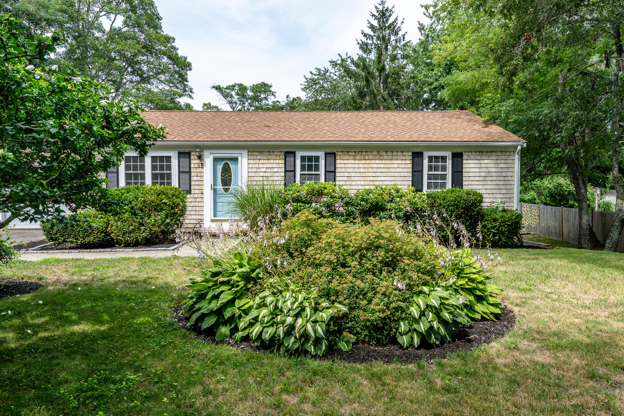 65 Elliott Road Centerville, MA 02632 - Photo 3 of 36 a front view of a house with a yard