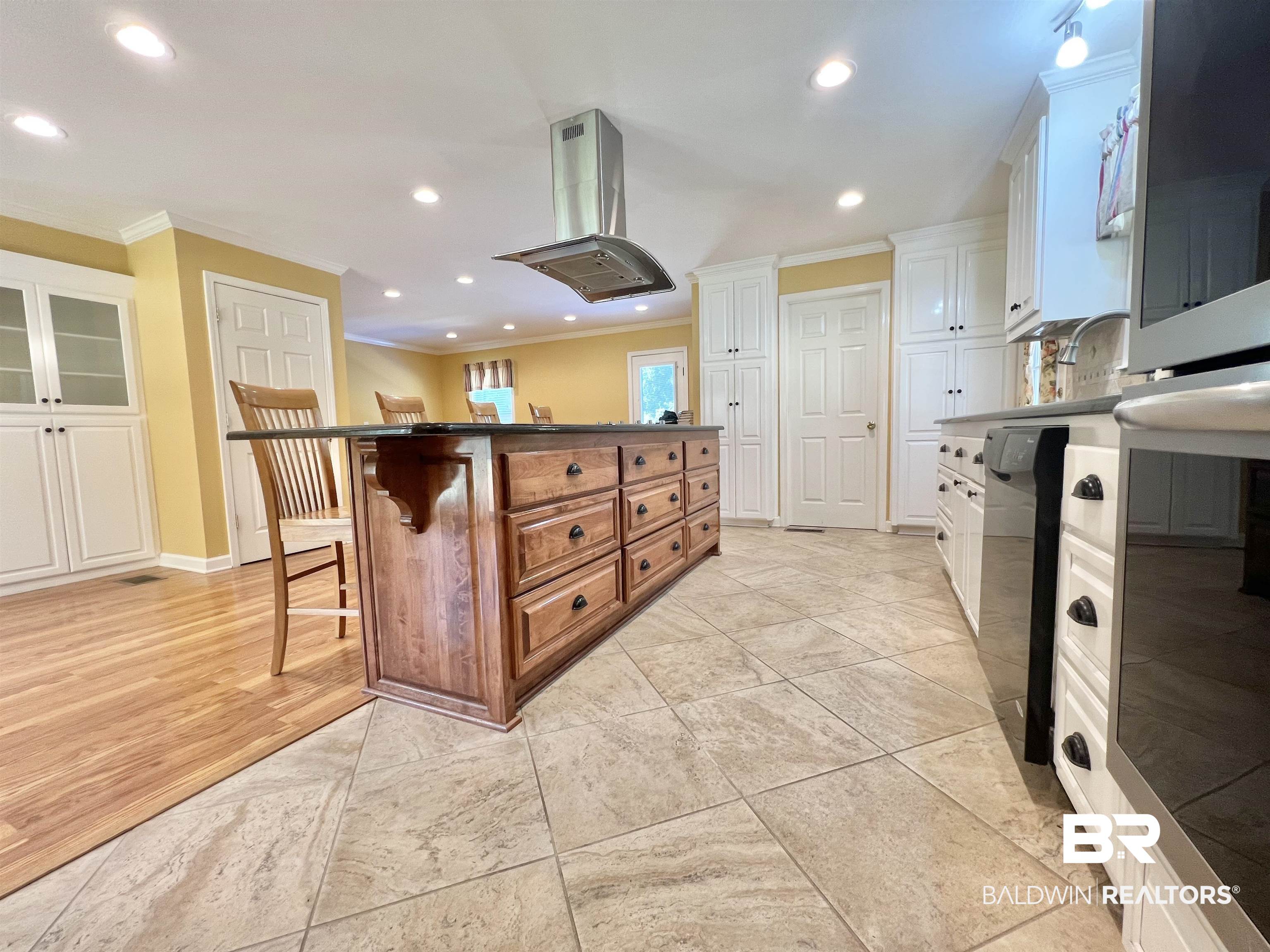2691 Appleton Road Brewton, AL 36426 - Photo 16 of 60 Kitchen featuring a kitchen bar, island exhaust hood, recessed lighting, crown molding, and a center island
