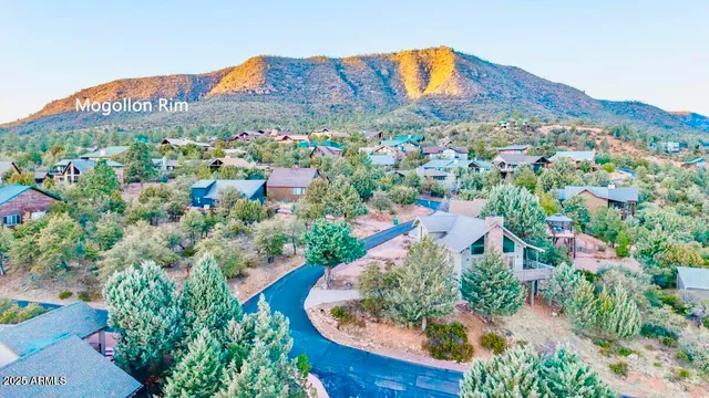 a view of a house with a yard and mountains