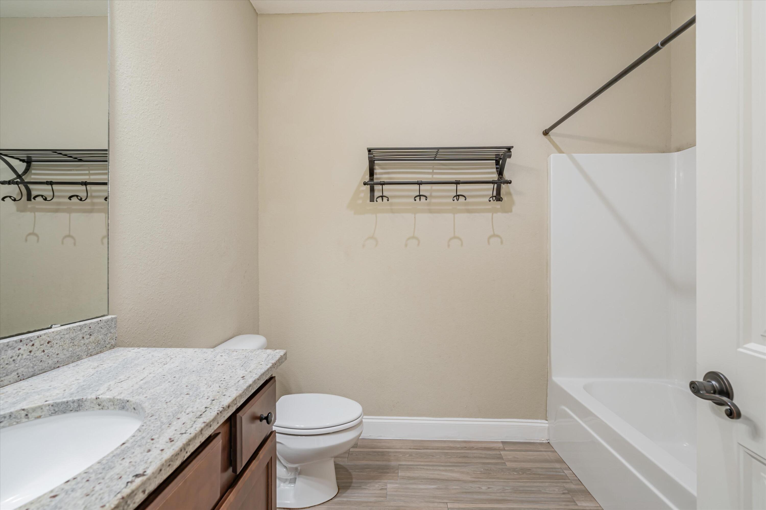 4529 Hermosa Road Crestview, FL 32539 - Photo 26 of 49 a bathroom with a granite countertop sink a toilet and shower