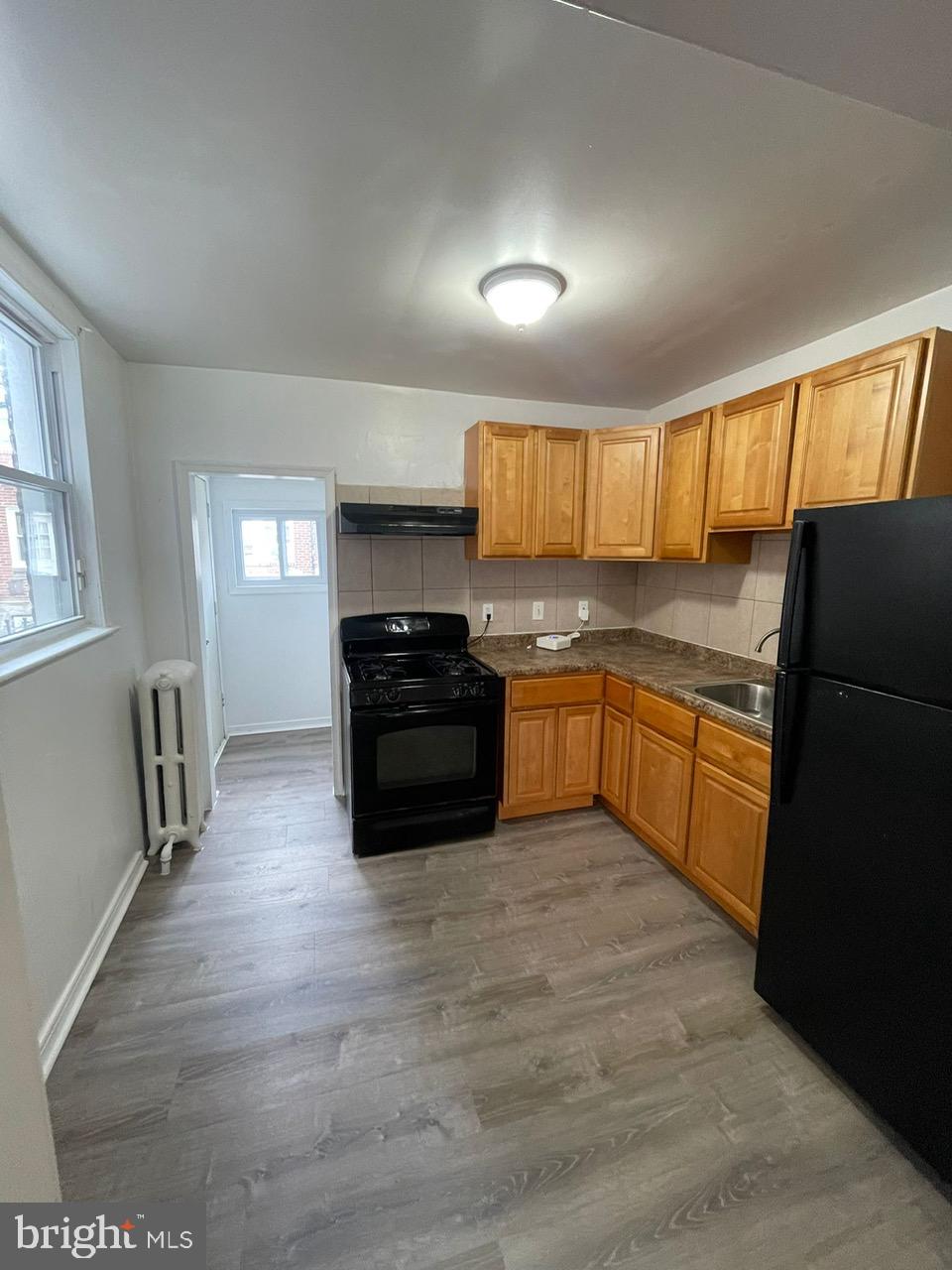 a kitchen with stainless steel appliances granite countertop a stove a sink dishwasher a refrigerator and a cabinets