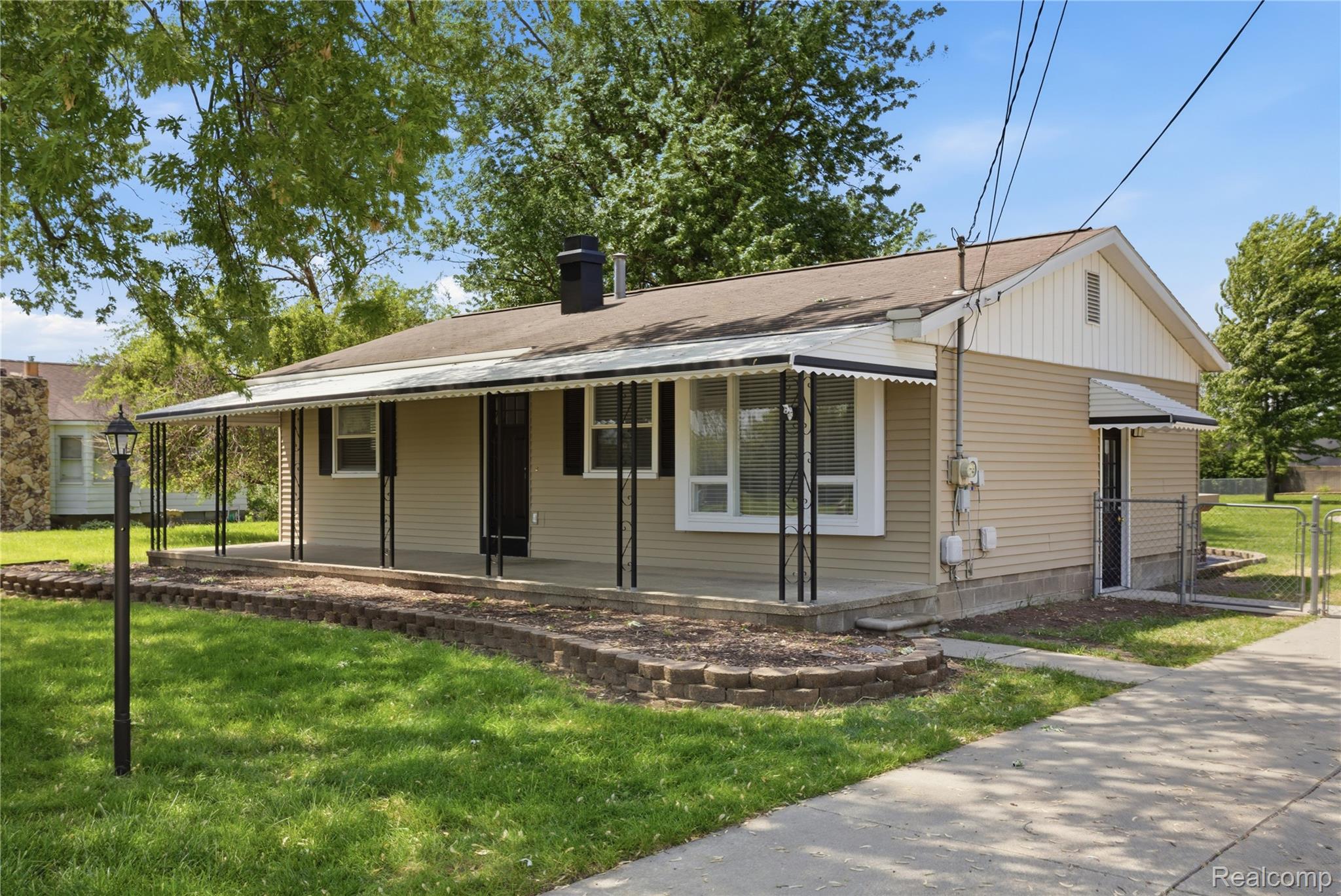 37257 Dundee Street Sterling Heights, MI 48310 - Photo 2 of 47 Single-story residence featuring light-toned horizontal siding and a covered front porch