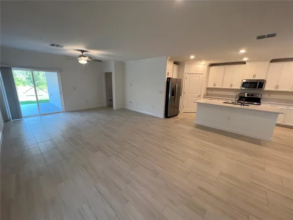a view of a kitchen with a sink and a stove top oven