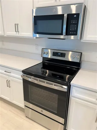 a stove top oven sitting inside of a kitchen