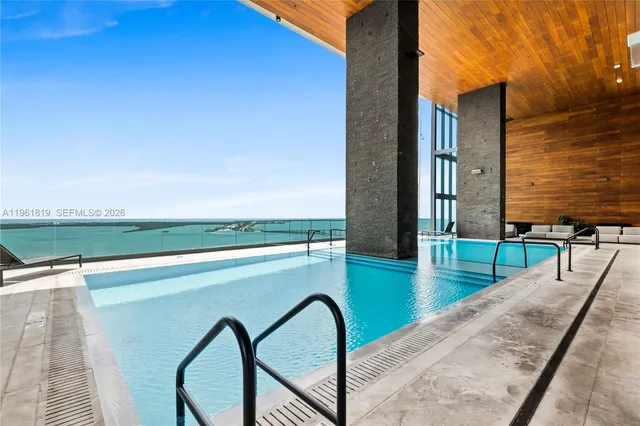 a swimming pool with outdoor seating and yard