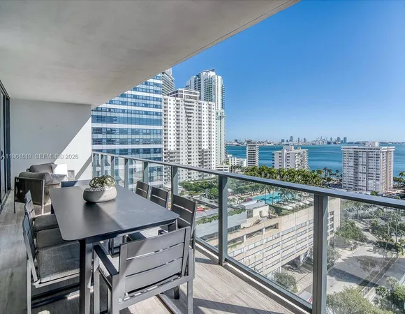 a view of a balcony with a table and chairs