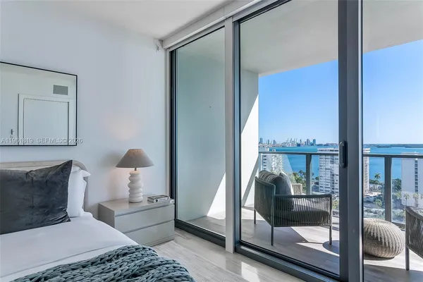 a bedroom with a bed and glass window