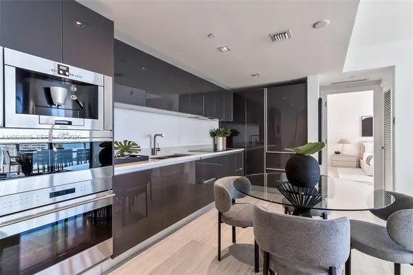 a kitchen with stainless steel appliances kitchen island granite countertop a sink and cabinets