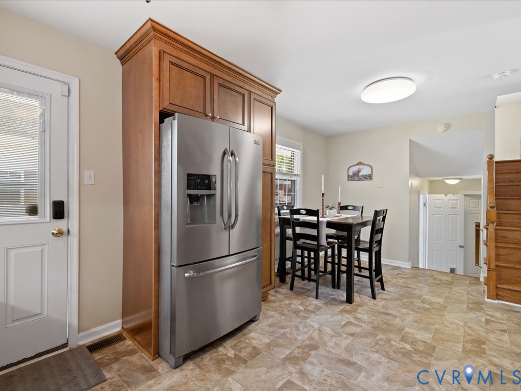 1455 Robindale Road Richmond, VA 23235 - Photo 10 of 29 a kitchen with stainless steel appliances granite countertop a refrigerator and a dining table