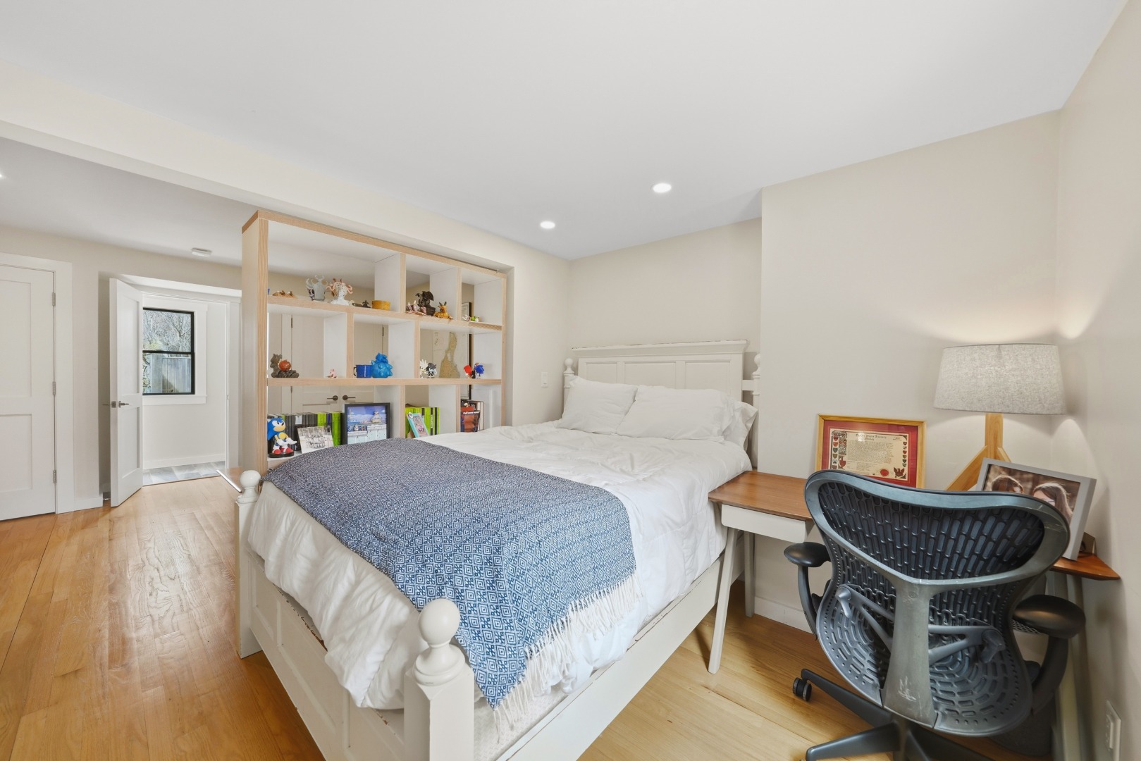 247 Polpis Road Nantucket, MA 02554 - Photo 27 of 52 a spacious bedroom with a bed and a bookshelf