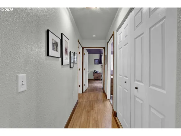 a view of hallway with wooden floor