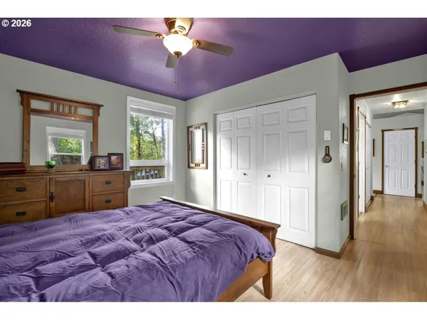 a bedroom with a bed dresser and a window