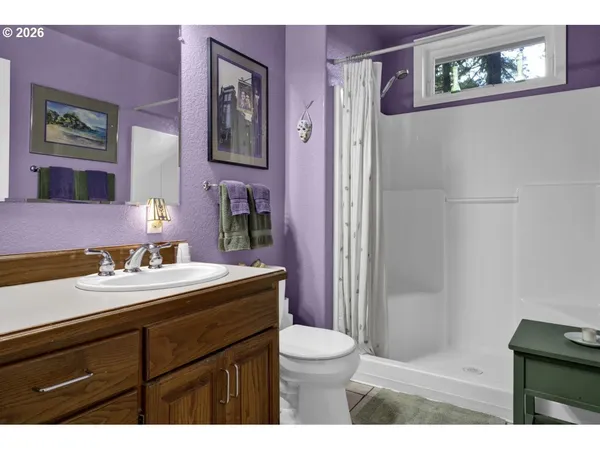 a bathroom with a sink vanity mirror and toilet