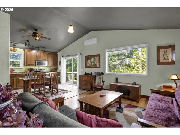 a living room with furniture a flat screen tv and a large window