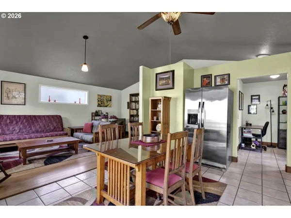 a living room with furniture a wooden floor and next to a window