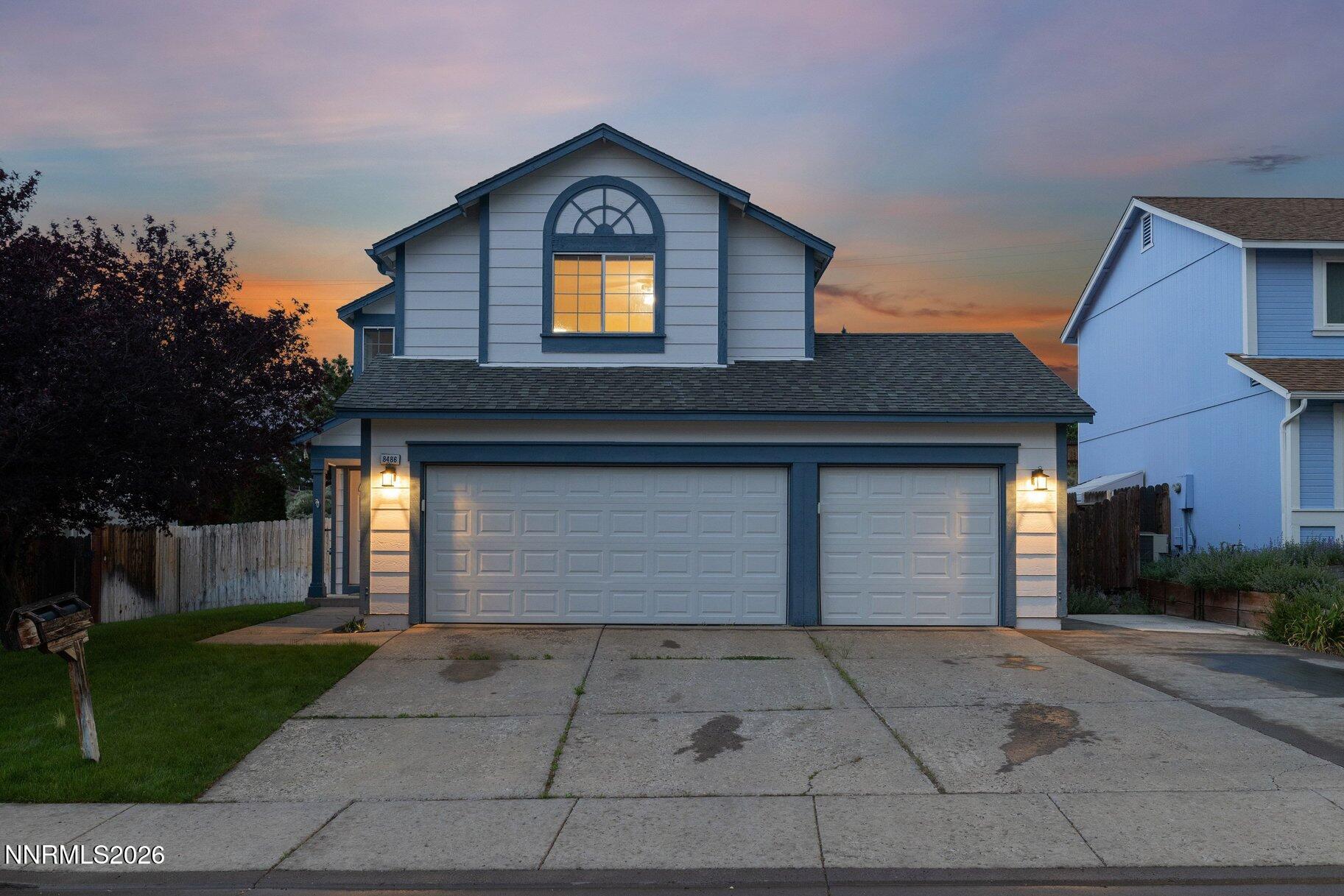 8486 Piper Place Reno, NV 89506 - Photo 68 of 80 a front view of a house with a yard and garage