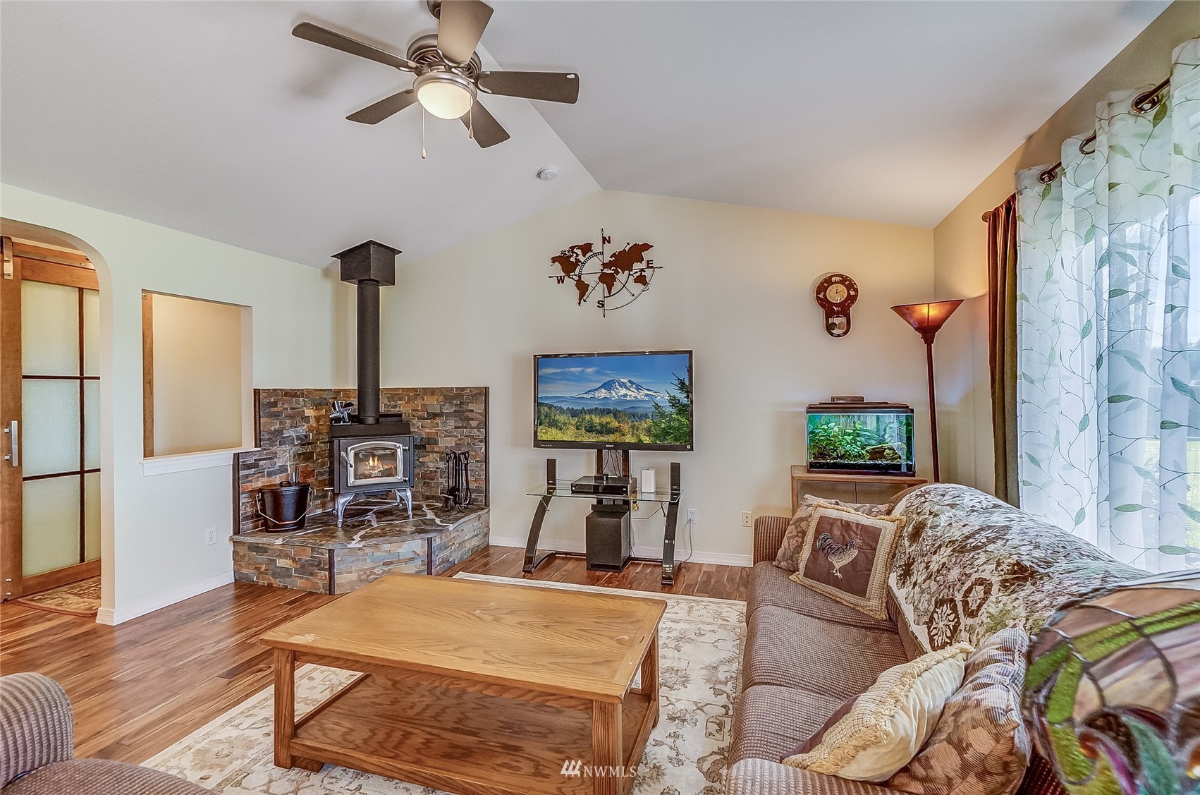 18039 Wild Violet Lane Southwest Rochester, WA 98579 - Photo 23 of 40 a living room with furniture and a flat screen tv
