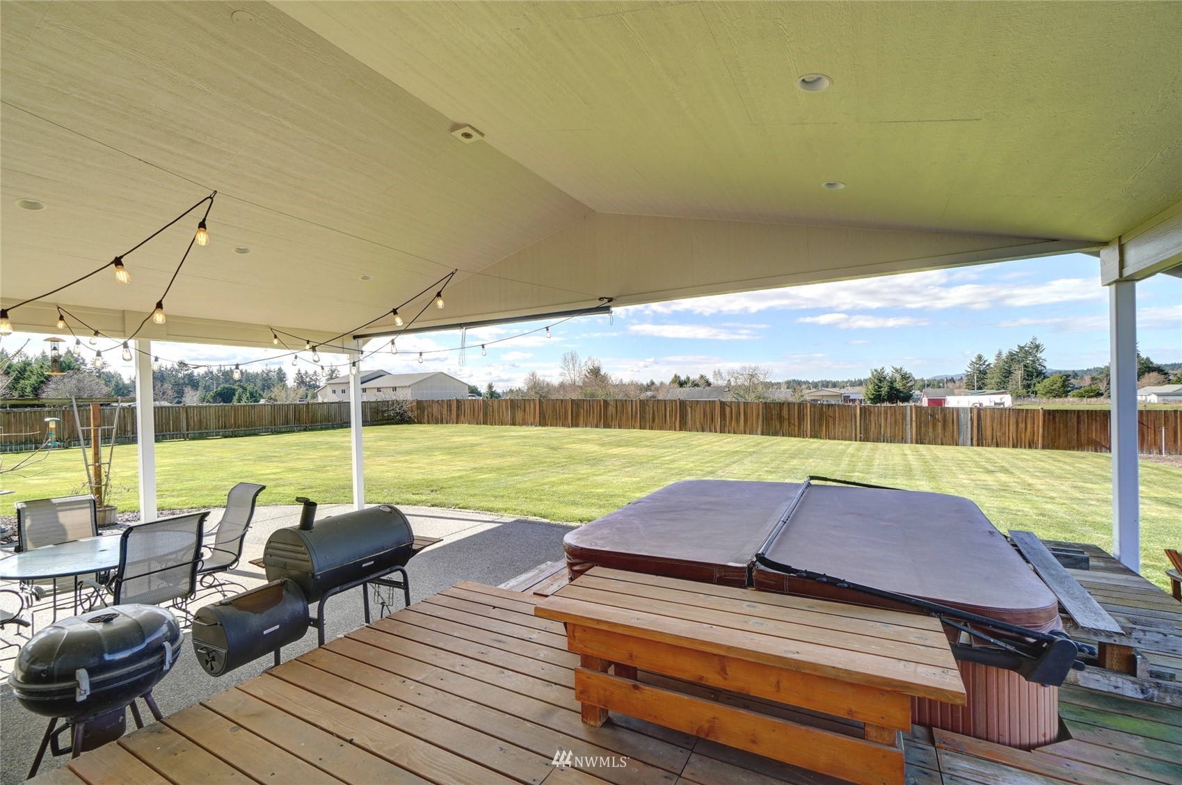 18039 Wild Violet Lane Southwest Rochester, WA 98579 - Photo 10 of 40 a view of a patio with lawn chairs under an umbrella