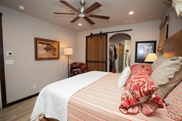 a bedroom with a bed and wooden floor