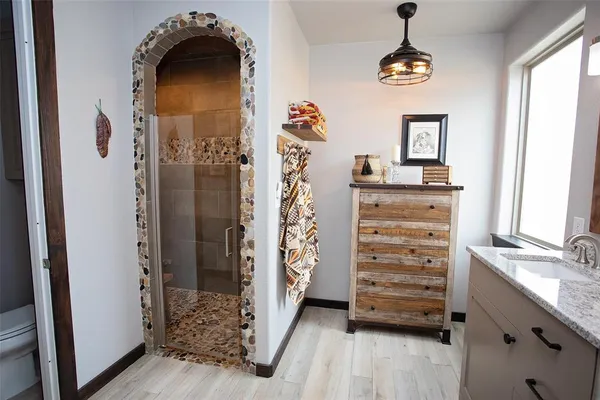 a bedroom with a large bed and a chandelier