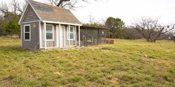 a backyard of a house with table and chairs
